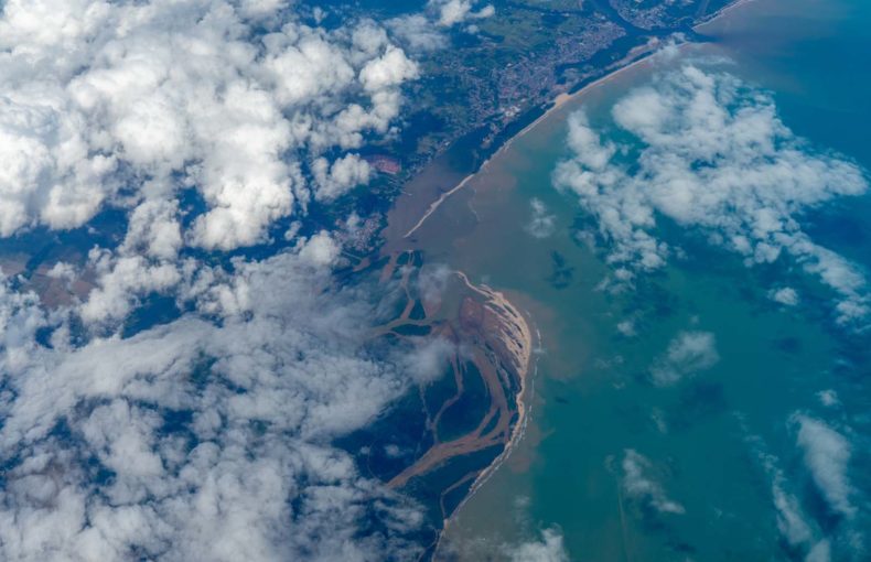 Aerial view of clouds over coastal land and sea in gulf of Thailand, landscape or cloudscape top view from airplane