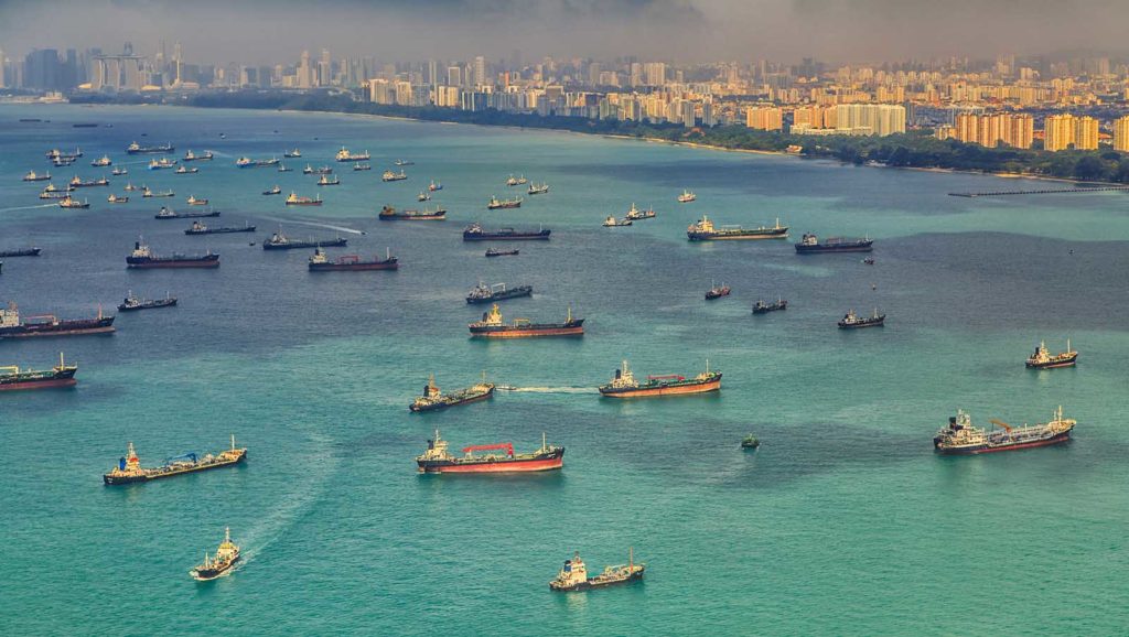 Landscape from bird view of Cargo ships entering one of the busiest ports in the world, Singapore.