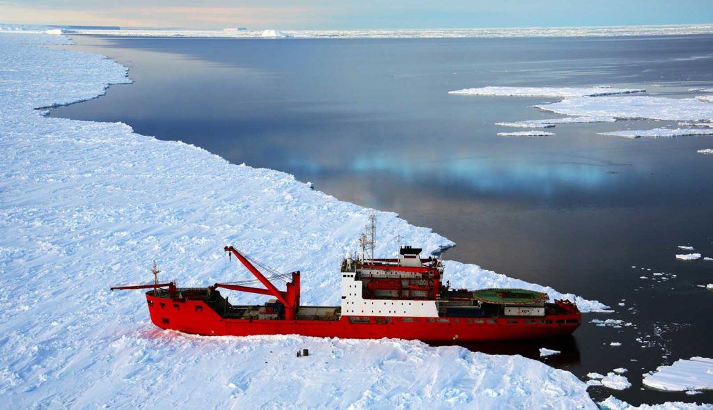 Cargo ship arrives in port for unloading on an ice floe