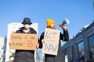 Climate change protesters with act now & there is no planet B signs