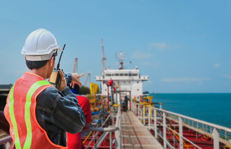 crew worker on tanker ship wearing safety helmet hard hat