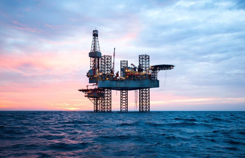 Offshore jack up rig in the middle of the sea at sunset