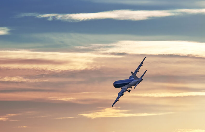 Plane unfolds at sunset