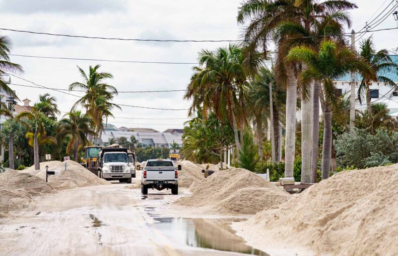 Trucks removing tons of sand from Bonita Beach Florida after Hurricane Milton Storm surge and flood