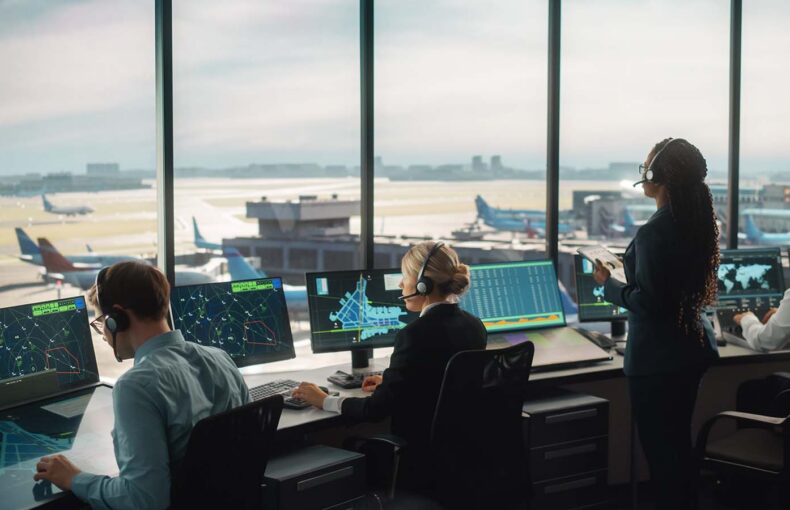 Air traffic control team working in a modern airport tower